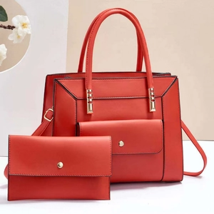 Red leather handbag and small clutch set with golden hardware and adjustable strap
