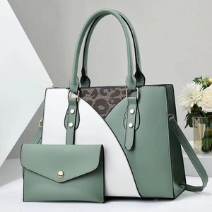 Detail view of the green and leopard print two-piece tote bag and matching clutch set