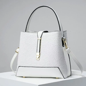 Elegant white lace texture bucket bag with gold hardware and versatile crossbody strap