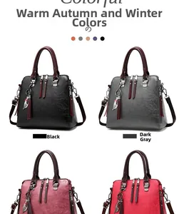 Detail view of multi-color leather handbags with metallic cat charm and tassel accents