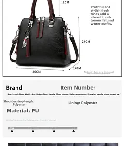 Detail view of black PU leather handbag with red handles and size dimensions 26x14x24cm