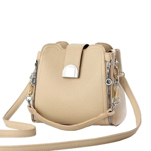 Beige lychee texture leather bucket bag with side zippers and silver metal buckle