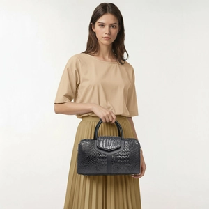 Detailed view of black crocodile pattern tote bag with distinctive Y-shaped leather trim