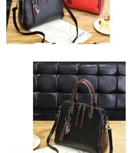 Close-up of dual-zipper PU leather handbags featuring cat charms and long tassel details