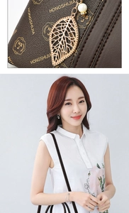 Detail of brown leather tote with gold HONGSHIJIA logo and pearl leaf pendant charm