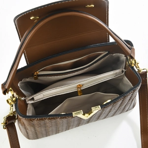Top view of deep brown woven handbag showing three interior compartments and gold hardware