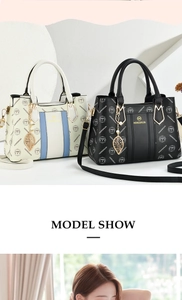 Detail of crossbody handbag with golden leaf charm and dual-tone white blue finish