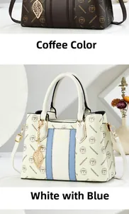 Close-up of elegant tote bags in coffee monogram and blue stripe with gold leaf charms