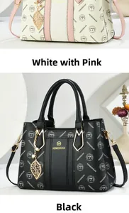 Detail of elegant handbags in white pink and black with golden leaf charm and logo pattern