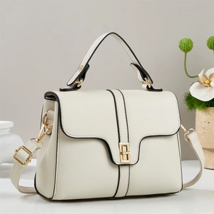 Elegant white pebbled leather crossbody bag with top handle and gold rectangular turn-lock