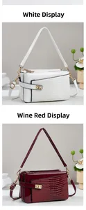 Detail of elegant crocodile pattern square handbags in white and wine red faux leather