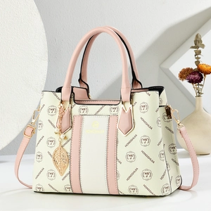 Fashionable cream white and pink tote bag with gold hardware and leaf charm pendant