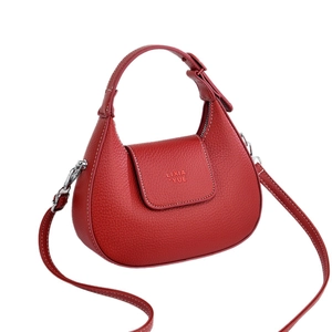 Minimalist red crescent leather crossbody bag with pebble texture and adjustable strap