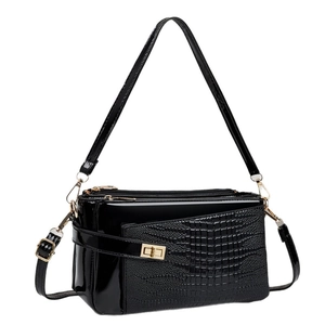 Elegant black crocodile-patterned handbag with triple-zip design and golden metal lock