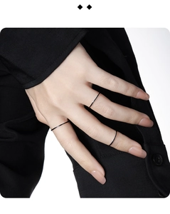 Minimalist black thin stackable rings on hand for a modern chic aesthetic