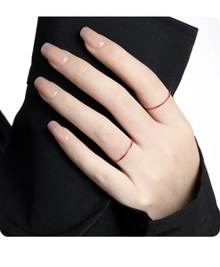 Close-up of minimalist slim S925 silver ring with red enamel detail on a model hand