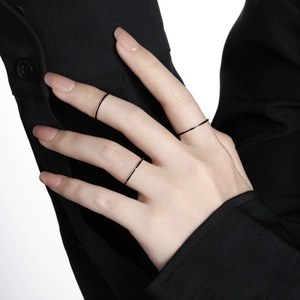 Set of minimalist slim black S925 sterling silver rings worn on fingers for women