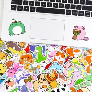 Assorted cute animal stickers on laptop including frog, lion and panda designs