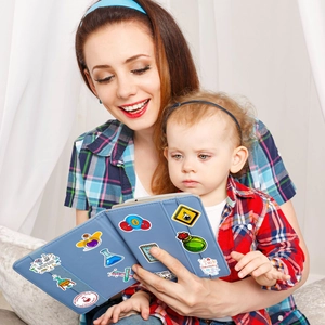 Close-up of science lab stickers featuring microscopes and beakers on a blue tablet cover
