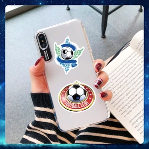 Close-up of clear phone case decorated with football club and winged soccer stickers