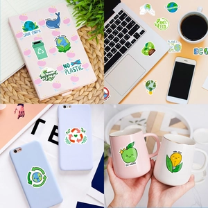 Close-up of eco-friendly graffiti stickers on laptops and mugs with Save Earth slogans