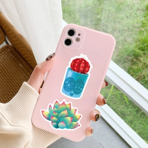 Pink matte phone case detailed with cactus and succulent stickers in a hand-held view