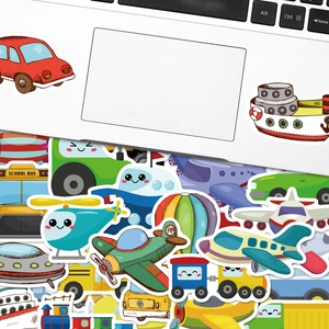 Close-up of cute cartoon transport stickers on a laptop featuring cars and buses