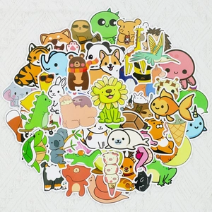 Flat lay of diverse cute animal stickers including lions and pandas on a white surface