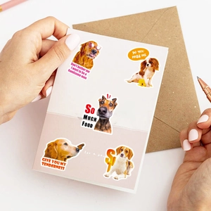 Macro shot of realistic dog stickers on a greeting card with matte finish details