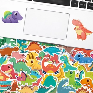 Detailed view of colorful cartoon dinosaur stickers on a white laptop surface