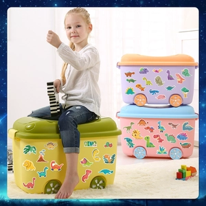 Close-up of colorful cartoon dinosaur stickers applied to a toy storage box surface