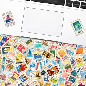 Retro travel destination stickers with world landmarks applied to a white laptop case