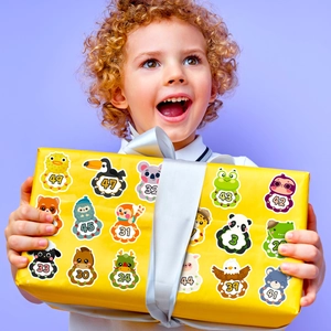 Kid holding a yellow gift box decorated with colorful cartoon animal number stickers