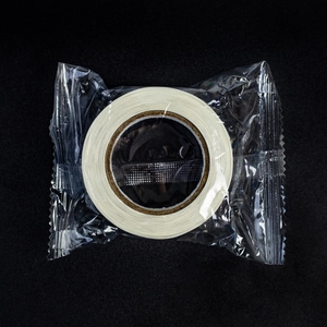 Detailed top view of a roll of holographic thank you stickers with protective film wrap