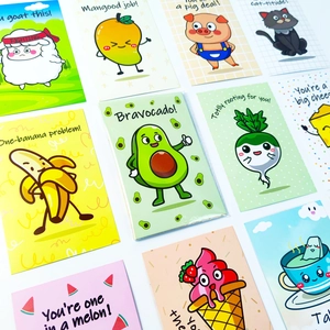 Close-up of colorful pun-themed postcards with cute cartoon animal and food illustrations