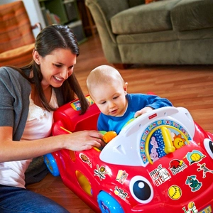Detail of softball theme stickers applied to a toy car surface in a home setting