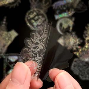 Macro detail of holographic celestial PET stickers showing sun and moon motifs