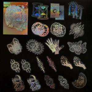 Macro view of holographic Magic World PET stickers with mystical sun and moon motifs