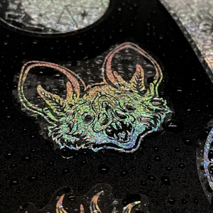 Macro shot of waterproof holographic laser sticker with bat design and metallic luster