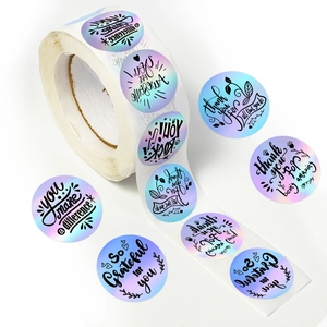 Macro view of laser rainbow stickers with Thank You text and iridescent holographic finish
