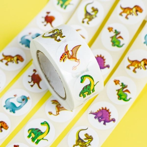 Close-up of cute cartoon dinosaur reward stickers in a roll on a bright yellow background