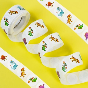 Roll of 500 cartoon dinosaur reward stickers displayed on a bright yellow background