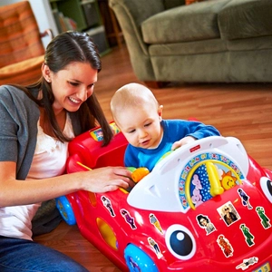 Close-up of stylish girl stickers on toy car in a cozy domestic family scene