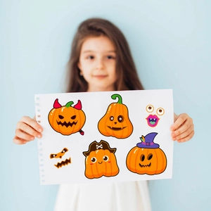 Close-up of DIY Halloween pumpkin face stickers featuring cartoon wizard and pirate hats