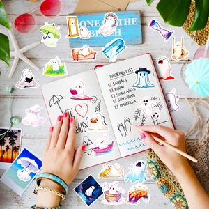 Close-up of cute cartoon ghost stickers used for summer vacation scrapbooking decoration