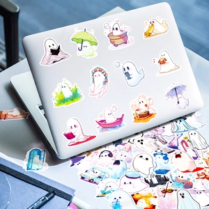 Detailed view of cute cartoon ghost stickers applied to a silver laptop back cover