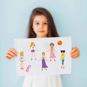 Detail of child holding a DIY princess dress-up sticker set with cute cartoon characters