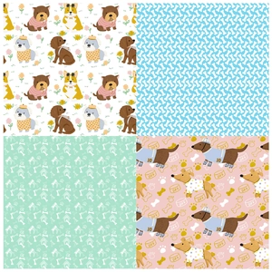 Detailed view of four cute dog themed scrapbooking paper patterns with bones and paw prints