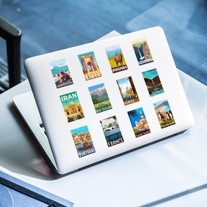 Retro travel poster stickers applied on a laptop lid with vintage landmark illustrations