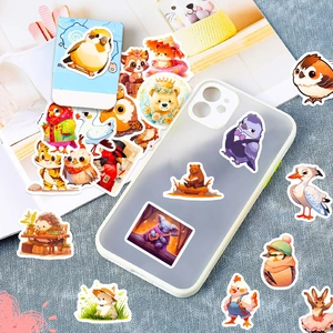 Cute cartoon animal stickers shown decorating a clear phone case on a textured surface